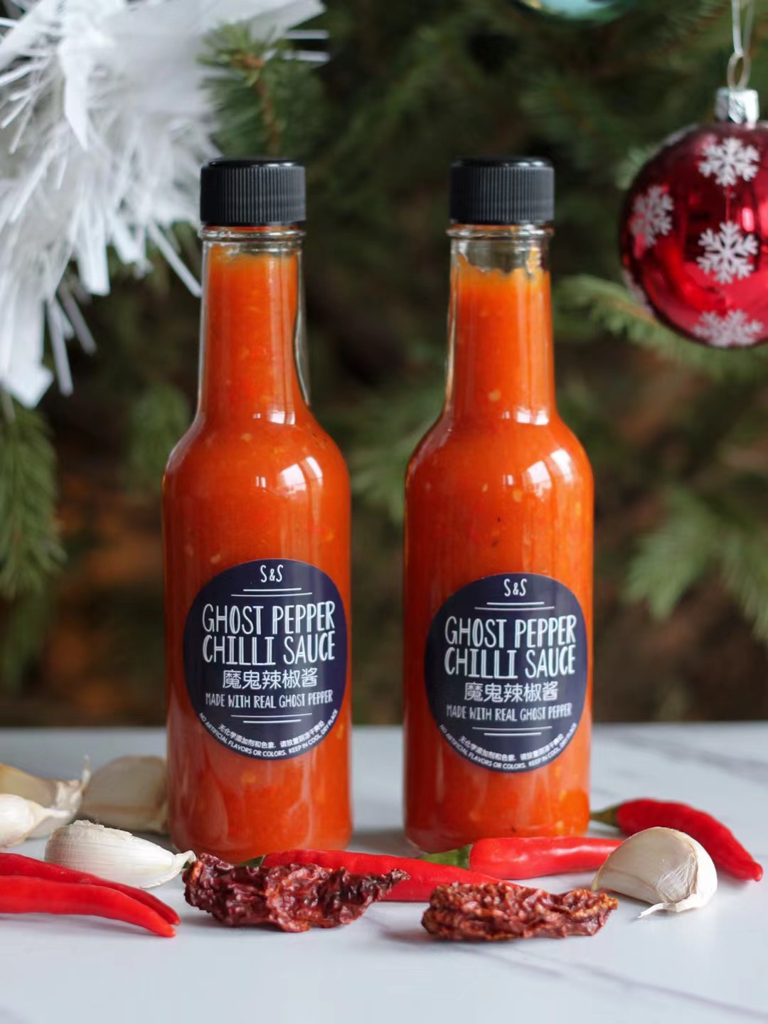 Ghost Pepper Chilli Sauce bottles with festive decorations